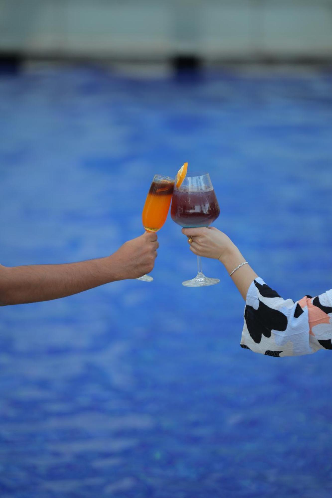 Novotel Hyderabad Airport Exteriör bild A toast with two glasses